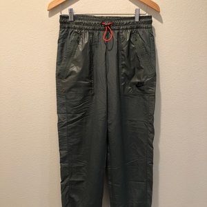 Women’s woven Nike sportswear pants.